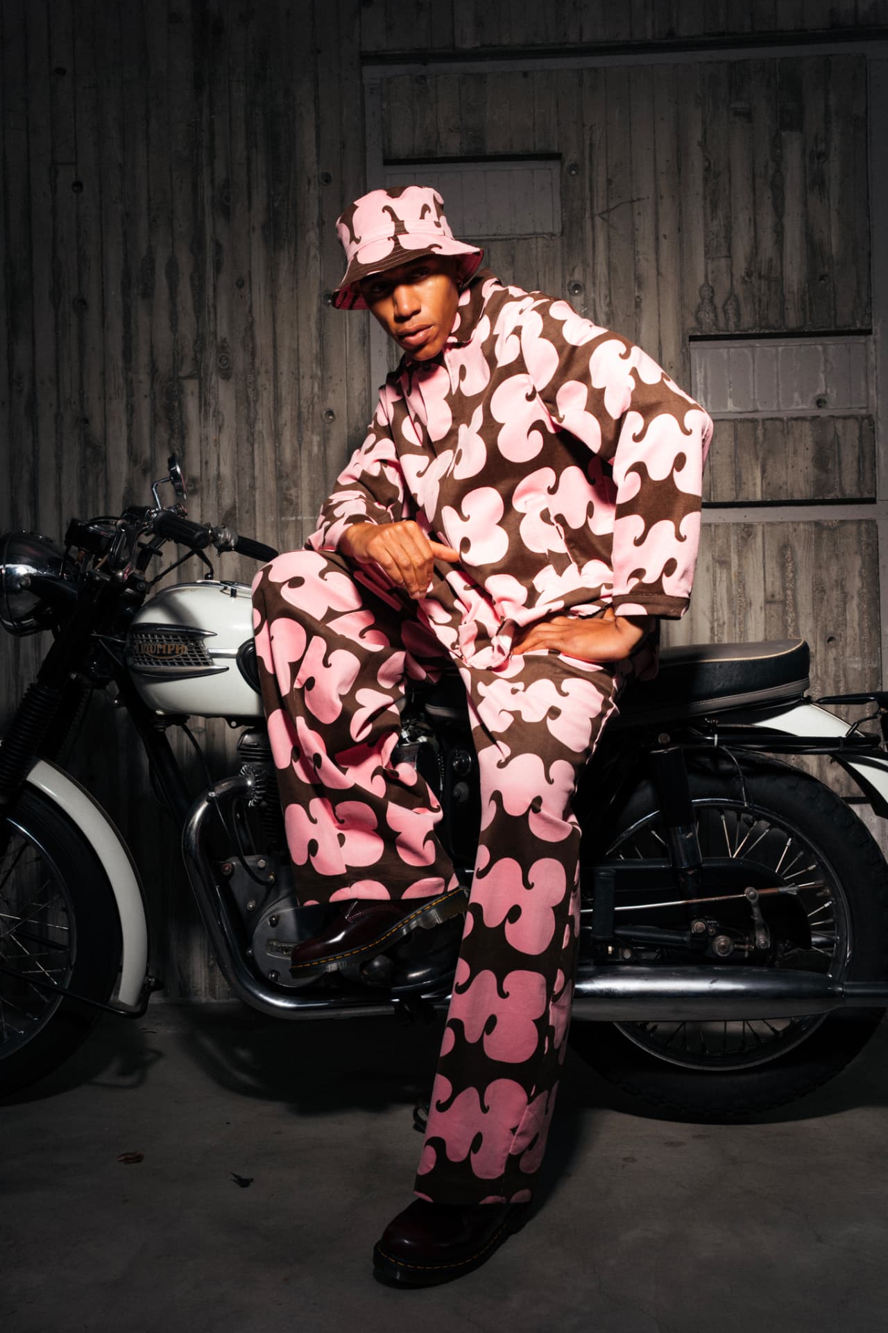 Luxe Sojourn opening image — pink and brown printed set photographed with a vintage motorcycle