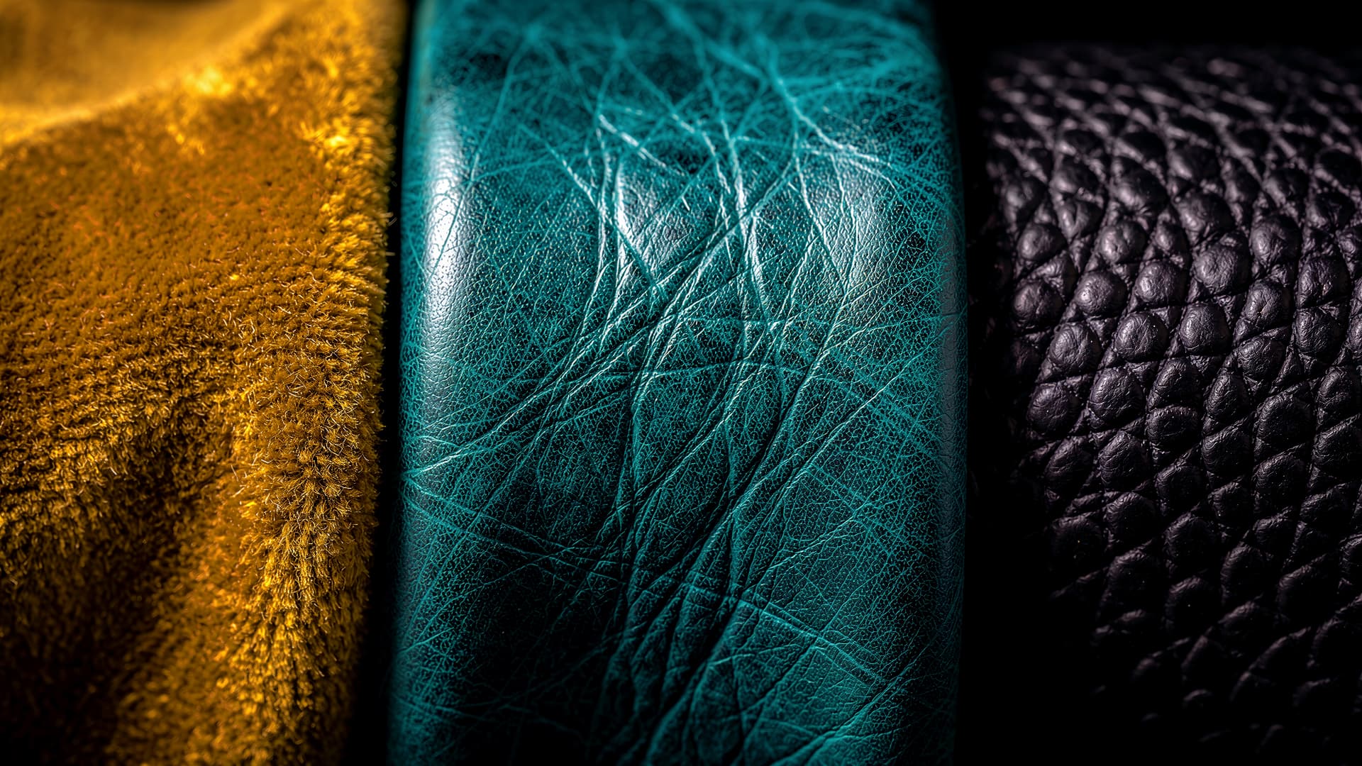Macro study of gold suede, teal leather and black pebbled leather side by side