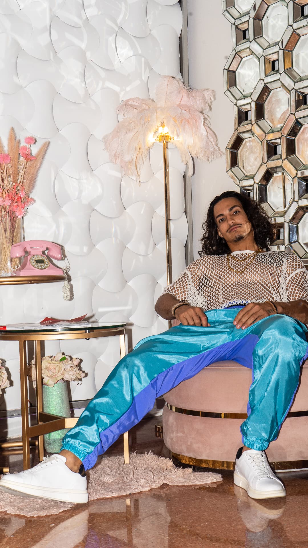 Teal satin lounge trousers photographed in a hotel lobby
