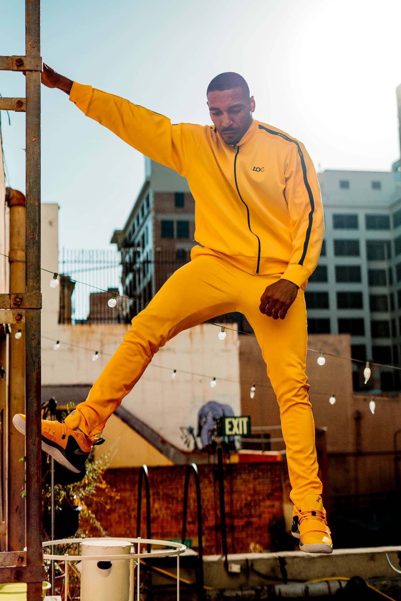 The Debut opening image — yellow track set photographed on a downtown Los Angeles rooftop