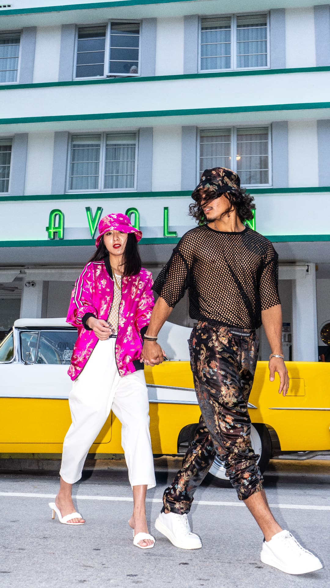Brocade bomber jackets styled as a pair outside the Avalon Hotel