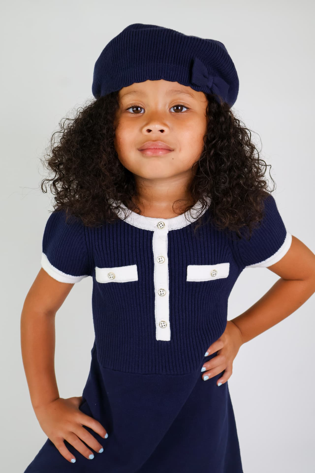 Milani’s World portfolio portrait in a navy outfit and beret