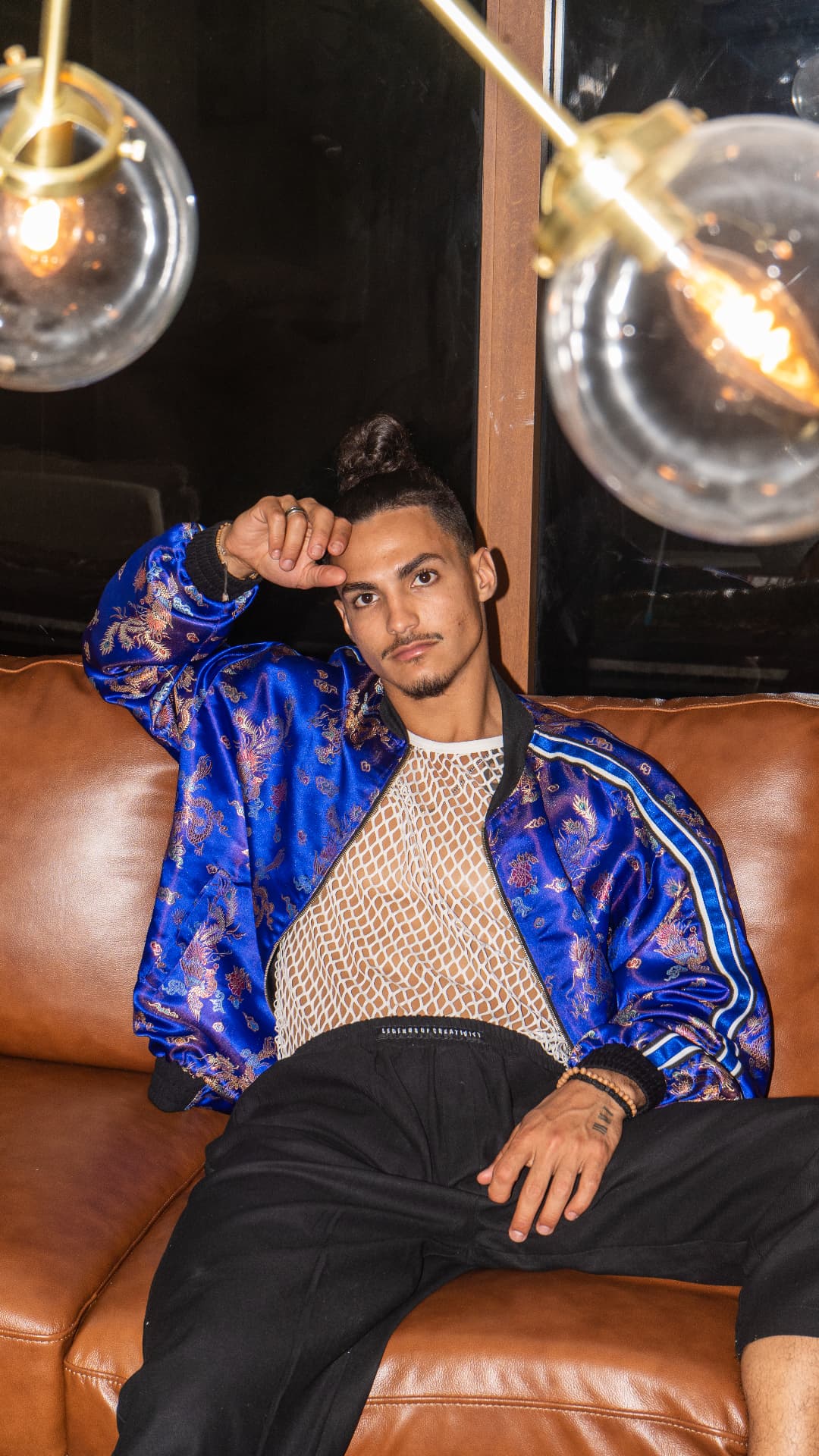 Cobalt brocade bomber photographed in a hotel lounge