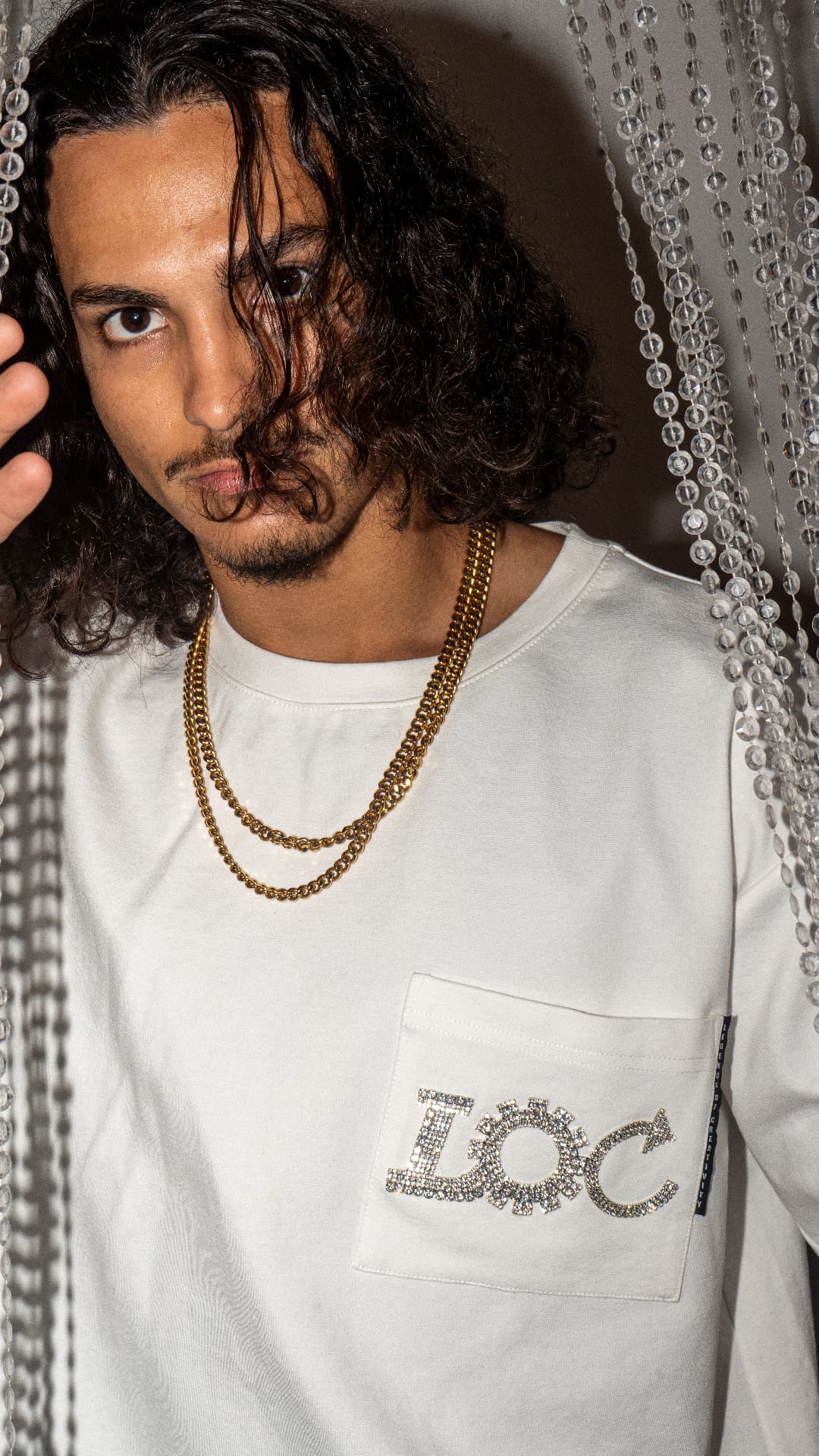 Crystal LOC pocket detail on a long-sleeve tee