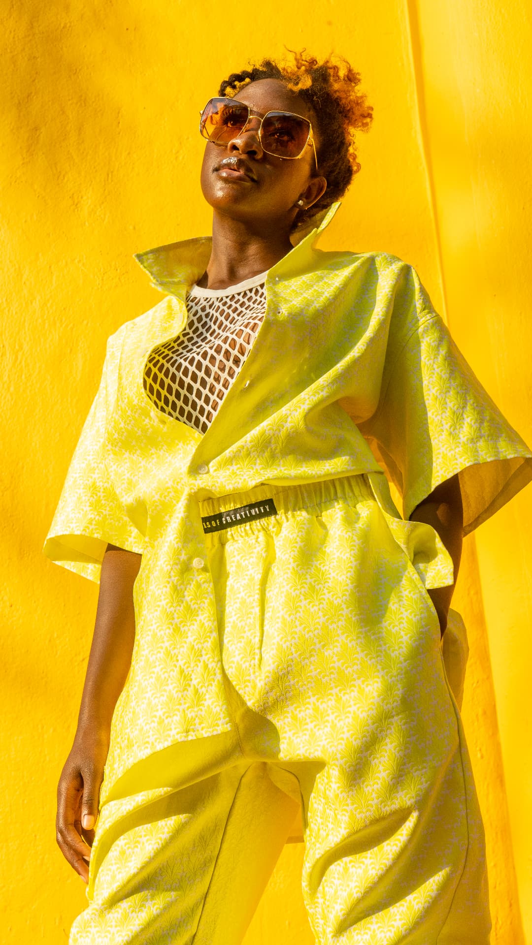 Yellow printed set photographed against a saturated yellow wall