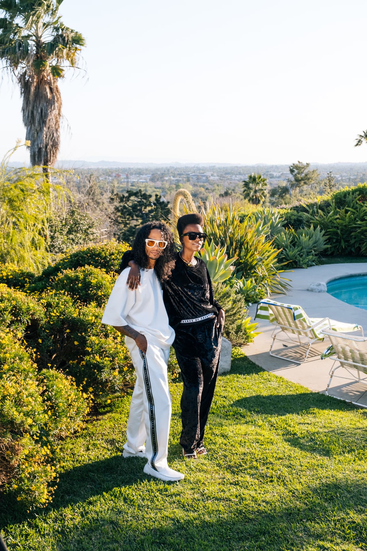 White set and black crushed-velvet set styled as a pair on the hillside pool deck