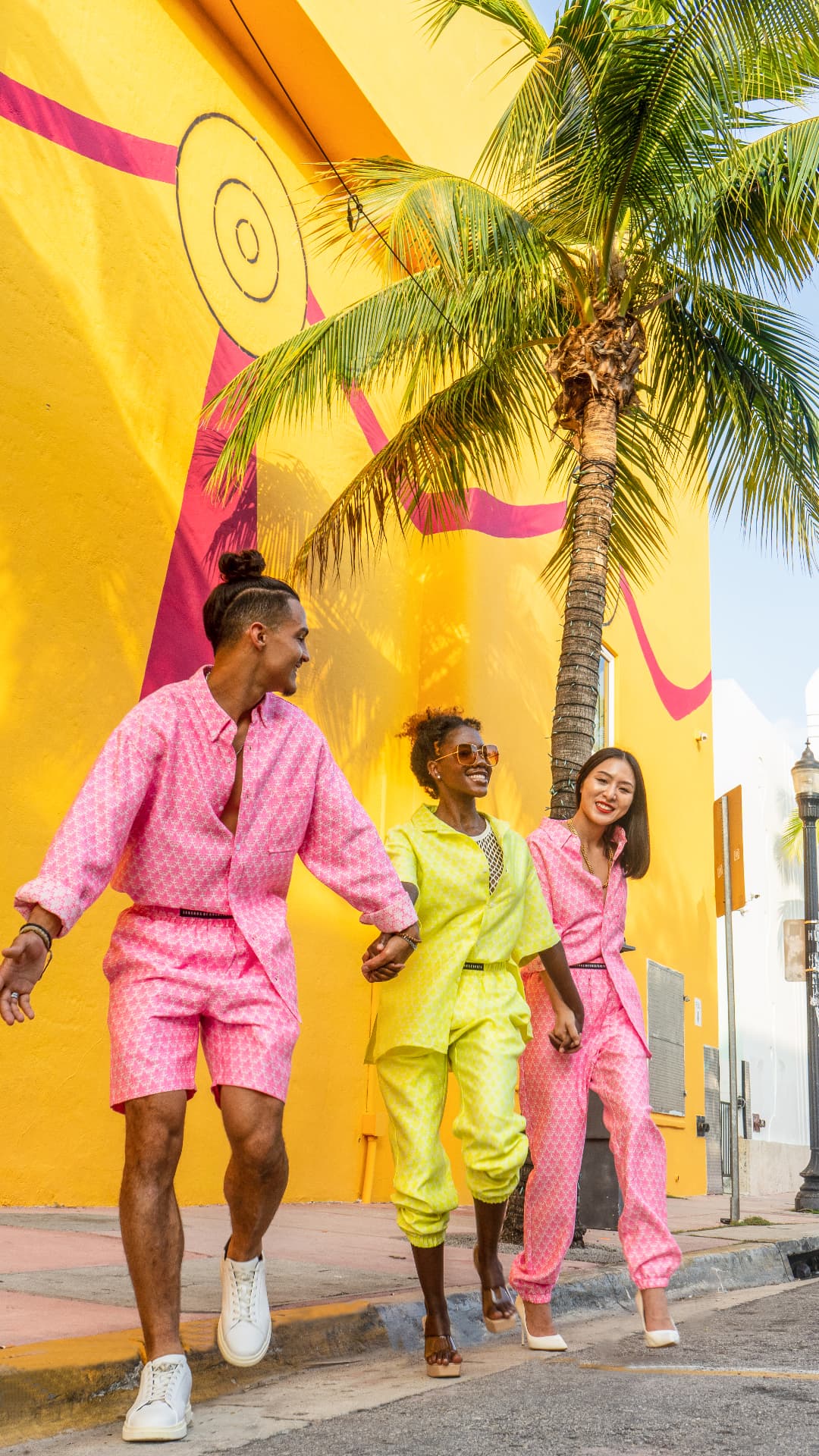 An Ode to Travel opening image — printed sets photographed against a yellow Art Deco wall in Miami