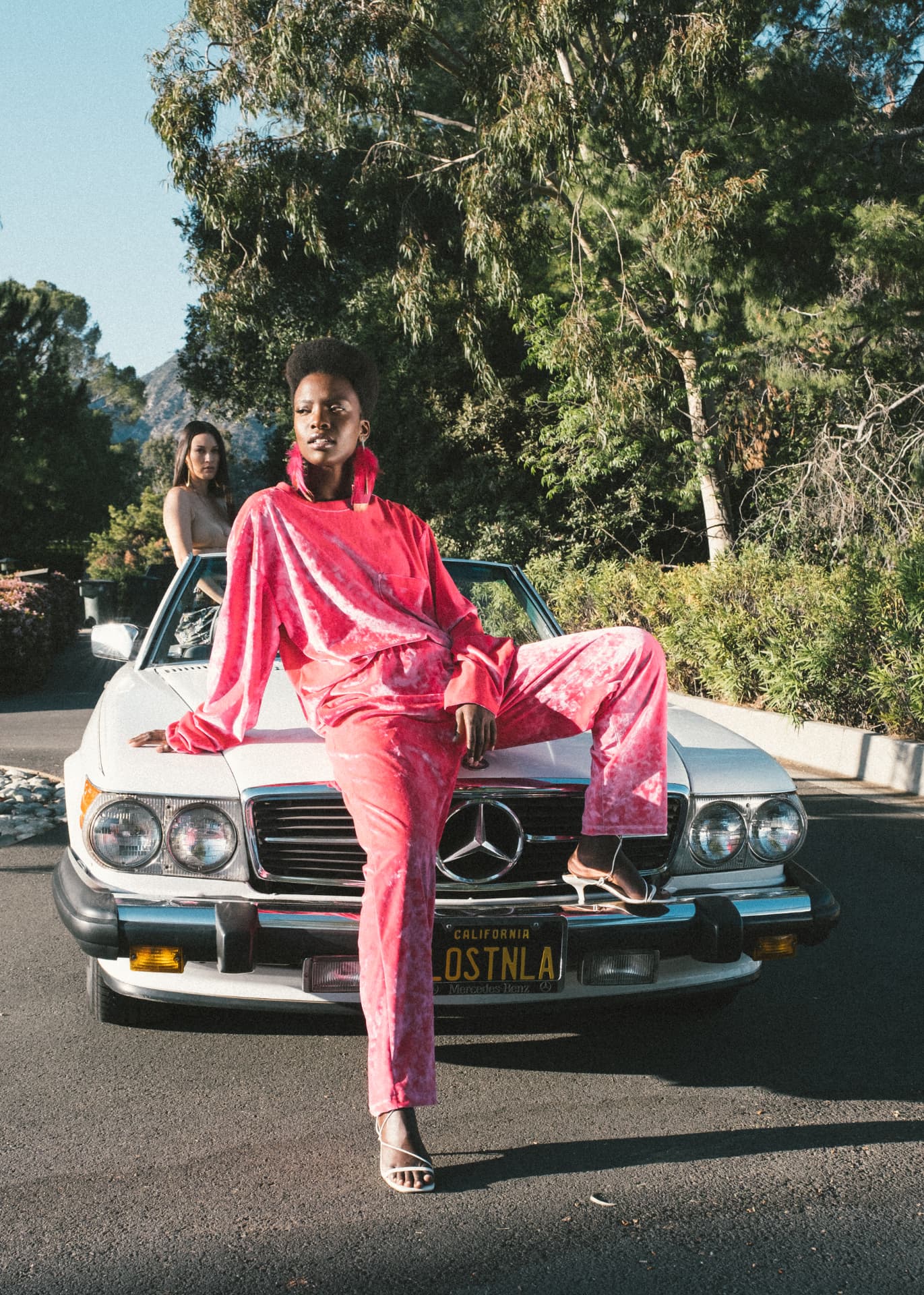 Hot-pink crushed-velvet set photographed on the vintage Mercedes